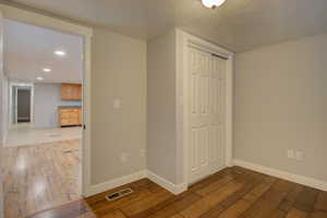 Interior space featuring a textured ceiling, light hardwood / wood-style floors, and a closet