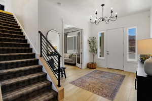 Entryway with a chandelier and light hardwood / wood-style flooring