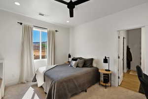 Bedroom featuring light carpet and ceiling fan