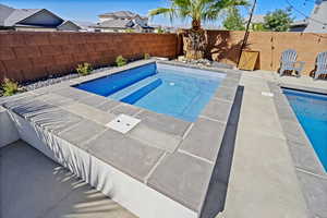 View of pool featuring a hot tub