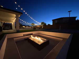 View of patio with an outdoor fire pit