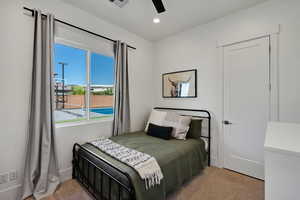 Carpeted bedroom with ceiling fan