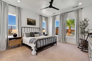 Carpeted bedroom featuring ceiling fan