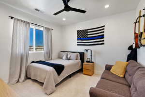 Carpeted bedroom with ceiling fan