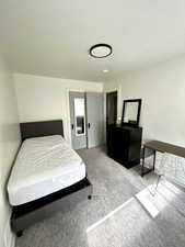 Carpeted bedroom featuring a textured ceiling