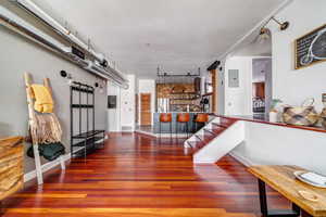 Interior space featuring electric panel and hardwood / wood-style floors