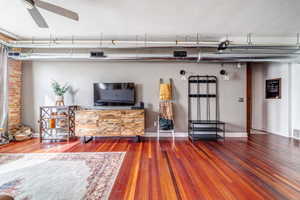 Living room featuring ceiling fan and hardwood / wood-style flooring