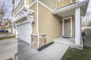 Doorway to property featuring a garage