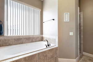 Bathroom with a relaxing tiled tub