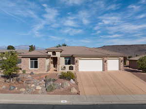 View of front of home featuring a mountain view and a garage