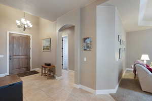 Tiled foyer with a chandelier