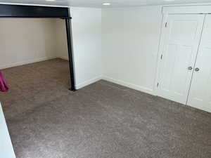 Basement with dark colored carpet