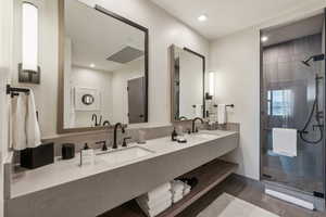 Bathroom featuring vanity and a shower with shower door