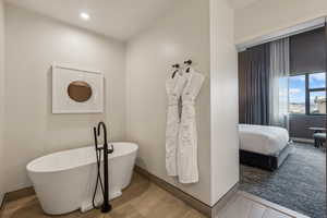 Bathroom with hardwood / wood-style floors and a bathtub