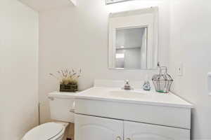 Bathroom featuring vanity and toilet