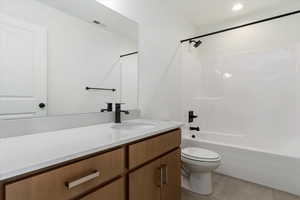 Full bathroom with hardwood / wood-style flooring, vanity, toilet, and bathtub / shower combination