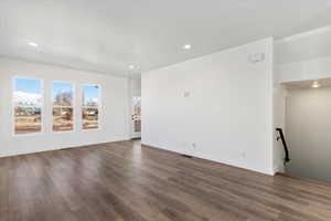 Empty room with dark hardwood / wood-style flooring