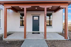 Property entrance featuring a patio area