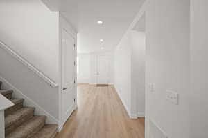 Hall with light hardwood / wood-style floors