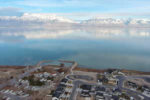 Birds eye view of property with a water and mountain view