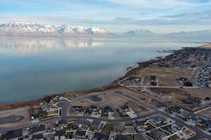 Drone / aerial view featuring a water and mountain view