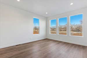 Empty room with hardwood / wood-style floors