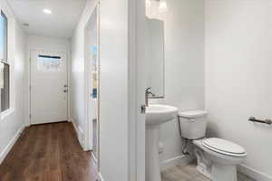 Bathroom featuring wood-type flooring and toilet