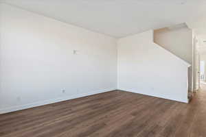 Unfurnished room with dark hardwood / wood-style flooring