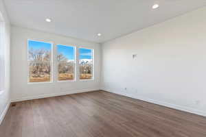 Empty room with dark wood-type flooring