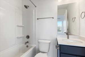 Full bathroom with vanity, toilet, and shower / washtub combination