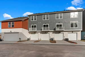 Back of house featuring a garage and central air condition unit