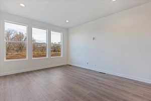 Unfurnished room featuring hardwood / wood-style flooring