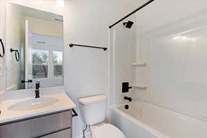 Full bathroom featuring shower / bathing tub combination, vanity, and toilet