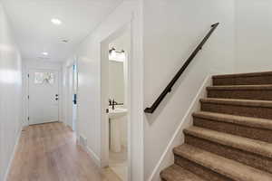 Staircase with hardwood / wood-style flooring