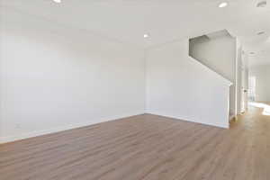 Empty room with light hardwood / wood-style flooring