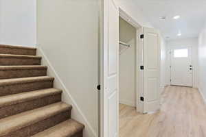 Stairway with hardwood / wood-style floors