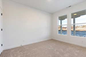 Spare room with light colored carpet