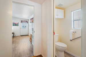 Bathroom featuring hardwood / wood-style flooring and toilet