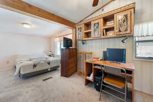 Bedroom featuring lofted ceiling with beams, light colored carpet, and ceiling fan