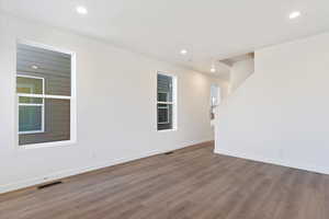 Empty room with hardwood / wood-style floors