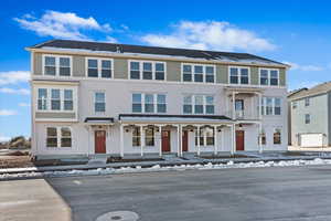 View of front of house featuring covered porch and a balcony