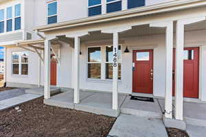 View of exterior entry featuring a porch