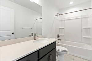 Full bathroom featuring tile patterned floors, vanity, shower / bathtub combination, and toilet