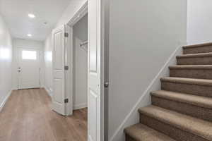 Staircase featuring wood-type flooring