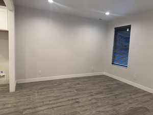 Empty room featuring dark hardwood / wood-style floors