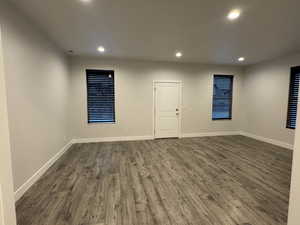 Empty room with dark wood-type flooring