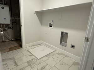 Washroom featuring hookup for an electric dryer, tankless water heater, and hookup for a washing machine