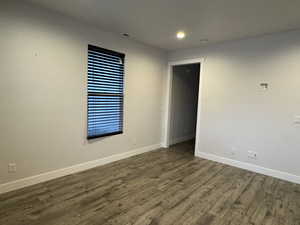 Unfurnished room featuring dark hardwood / wood-style flooring