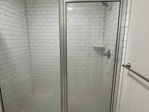 Bathroom with a shower with shower door