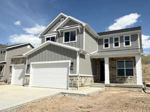 Craftsman-style home with board and batten siding, a garage, a porch, stone siding, and concrete driveway